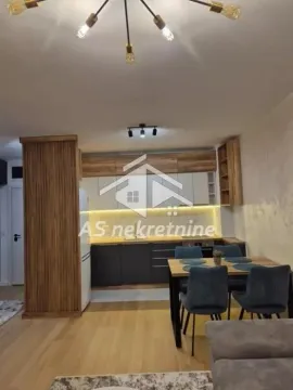 Modern kitchen with a dining area and built-in wooden cabinetry. - image 11
