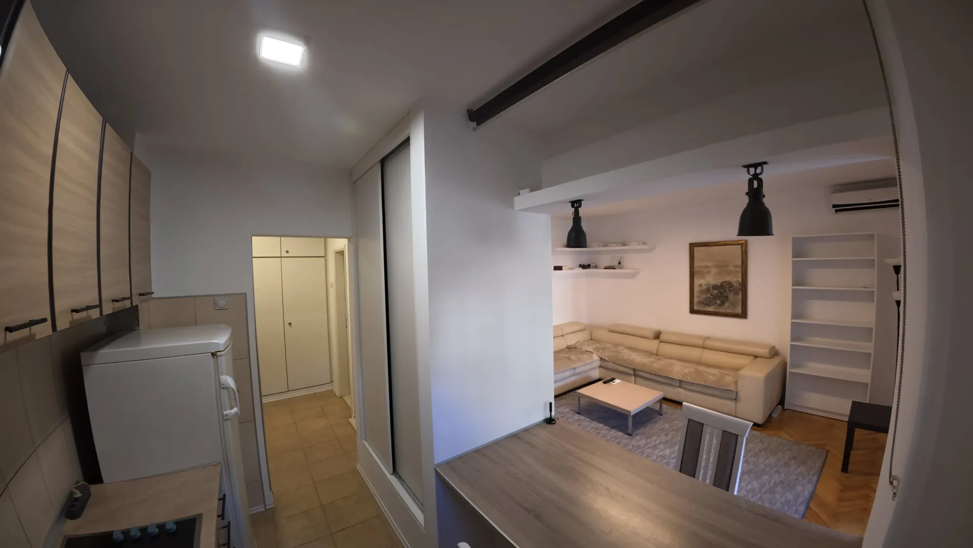 View of the living room and kitchen in the apartment.