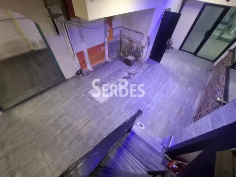 Empty space under renovation with tiled floor and stairs. - image 7