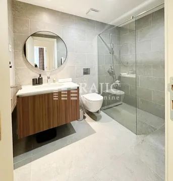 Modern bathroom equipped with a walk-in shower and washbasin. - image 3