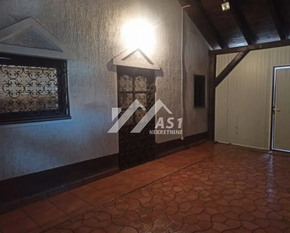 Covered porch with tiled flooring and a wooden ceiling.