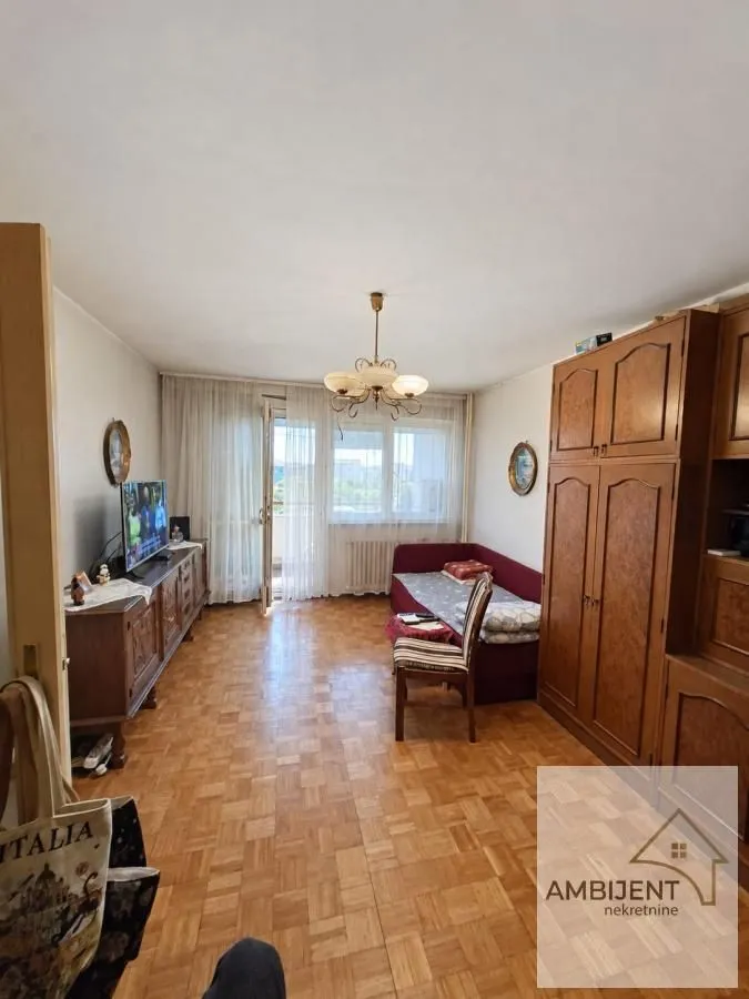 Living room with wooden furniture and parquet flooring.