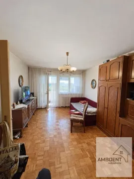 Living room with wooden furniture and parquet flooring. - image 3