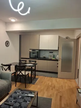 Modern kitchen with dining area and living space in bright tones. - image 3