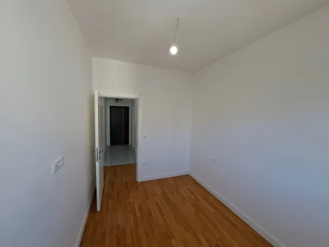 Empty room with parquet flooring and white walls. - image 15