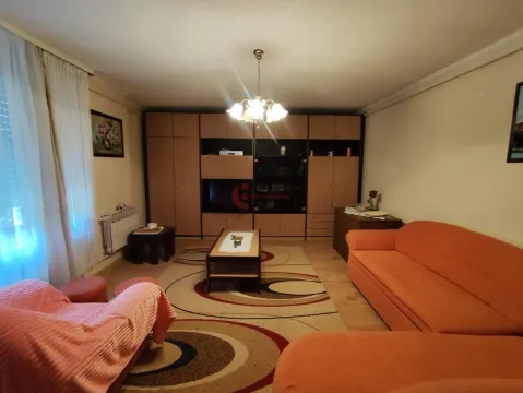 Living room with a sofa set, large wardrobe, and rug. - image 5