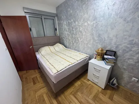 Bedroom with a double bed, nightstand, and parquet flooring. - image 5