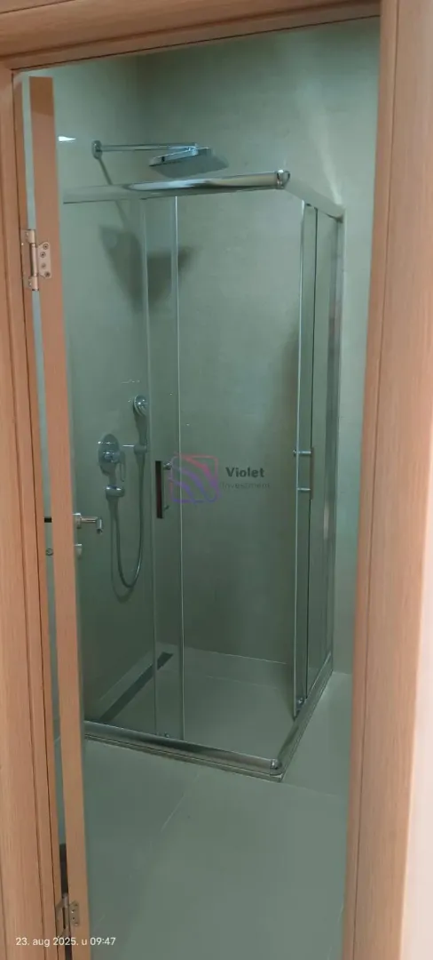 View of the shower cabin with glass partition in the bathroom.