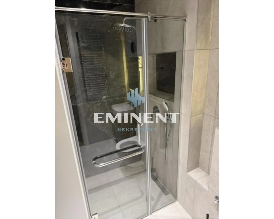 Modern bathroom with a glass shower enclosure.