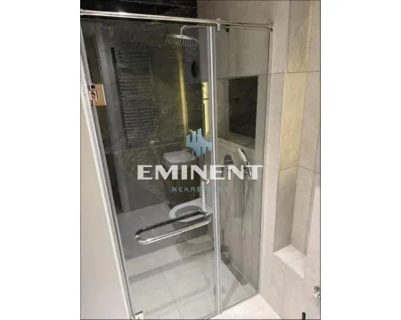 Modern bathroom with a glass shower enclosure. - image 7