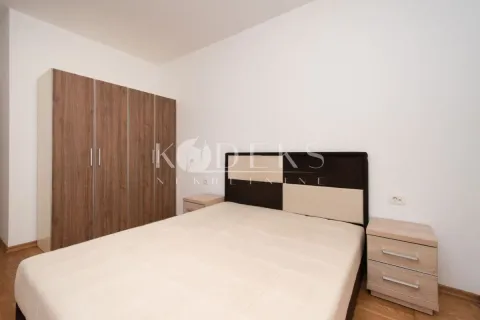 Bedroom with a double bed, wooden wardrobe, and bedside tables. - image 6