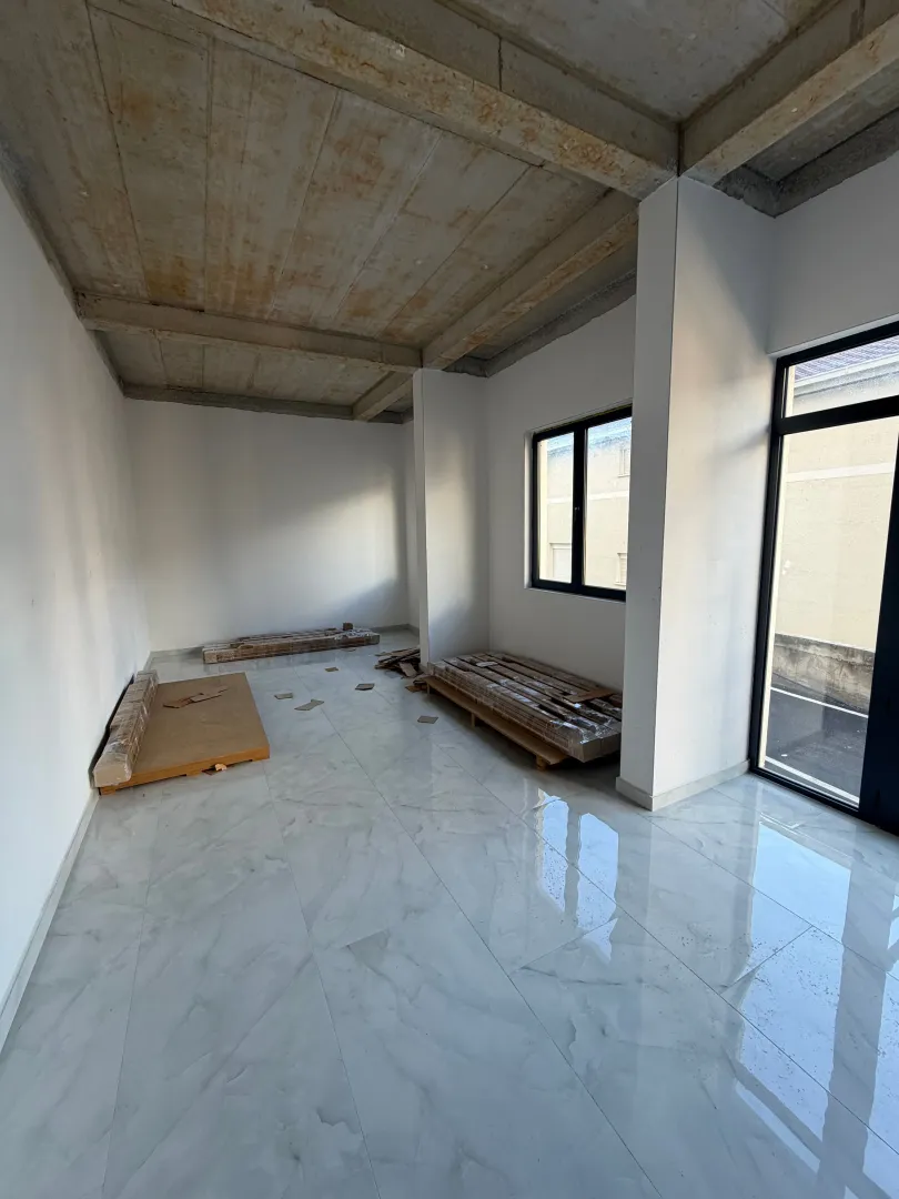 Unfinished room with ceramic floor tiles and concrete ceiling.