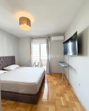 Furnished bedroom with a double bed, TV, and access to the terrace. - image 3