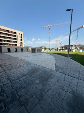 Paved plateau in front of a residential building under construction. - image 10