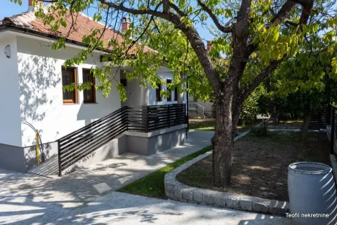 Pogled na dvorište i spoljašnjost kuće sa uređenom baštom. - image 3