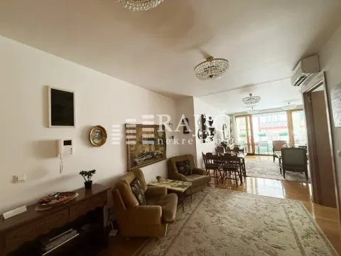 Spacious living room with seating furniture and a dining area in the back. - image 13