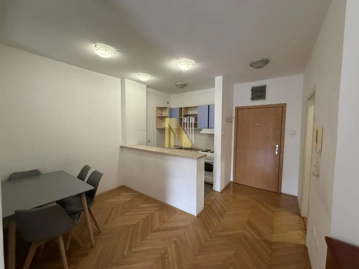 Small kitchen with a breakfast bar and dining table in the apartment.