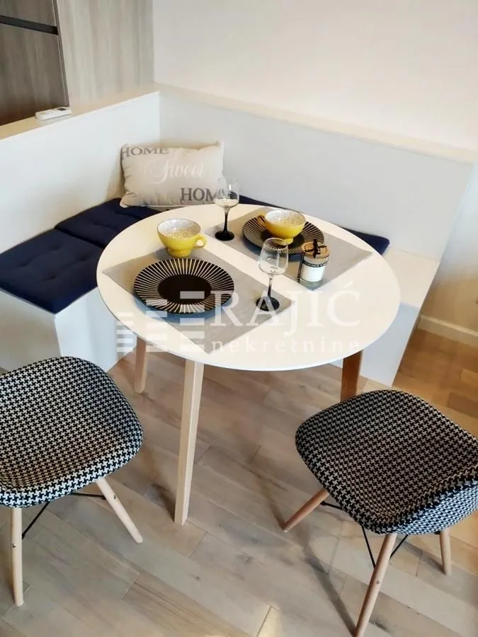 Dining area with a table, chairs, and corner bench.