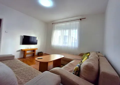 A bright living room with a seating set and a wall-mounted TV. - image 6