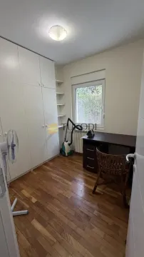 Small room with a large built-in wardrobe, desk, and a window. - image 16