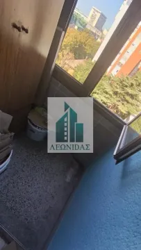 Small enclosed balcony space with a window and a city view. - image 11
