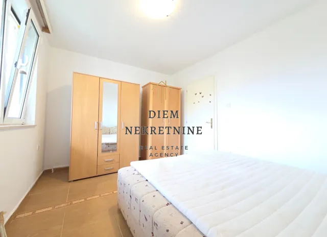 Furnished bedroom with wardrobes and a bed.