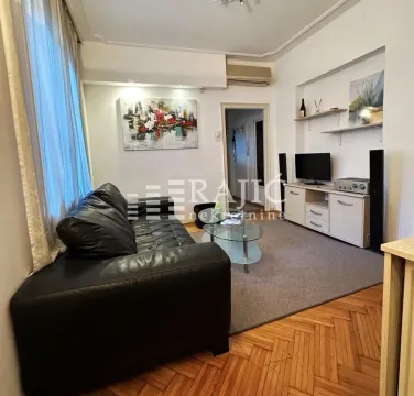 Living room with sofa, TV unit and parquet flooring. - image 2
