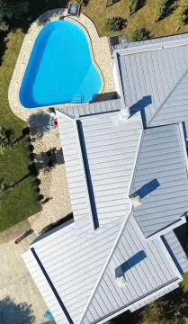 Aerial view of the house roof and swimming pool in the courtyard. - image 5