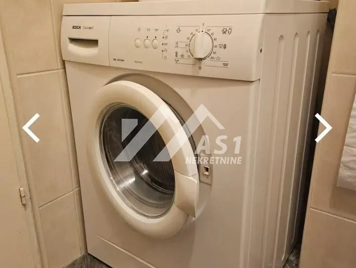 White washing machine in the bathroom.