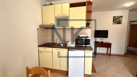 Smaller kitchen integrated into the living room with fitted units and appliances. - image 6