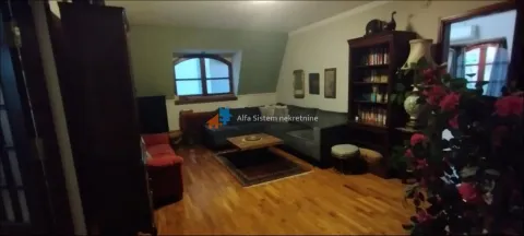 Living room with a sofa set, wooden flooring, and a bookcase. - image 13