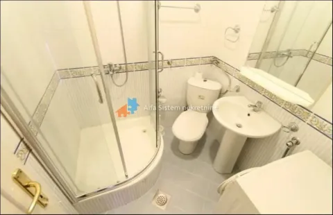 Bathroom with a shower cabin, washbasin, and toilet. - image 20