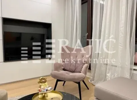 Living room with a comfortable armchair and a TV. - image 4