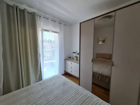 Bright bedroom featuring a large wardrobe and access to a balcony. - image 6