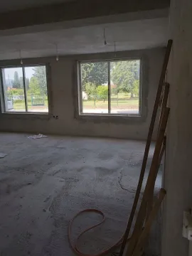 Spacious room in the rough construction stage with large windows. - image 9