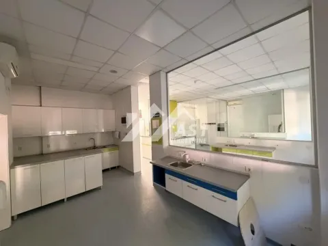 Spacious kitchen with white units and a sink. - image 2