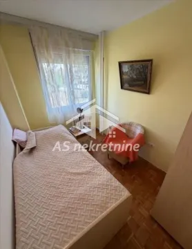 Smaller bedroom with a bed and an armchair. - image 12
