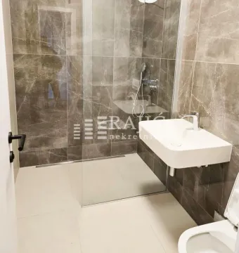 Modernly equipped bathroom with a walk-in shower and washbasin. - image 8