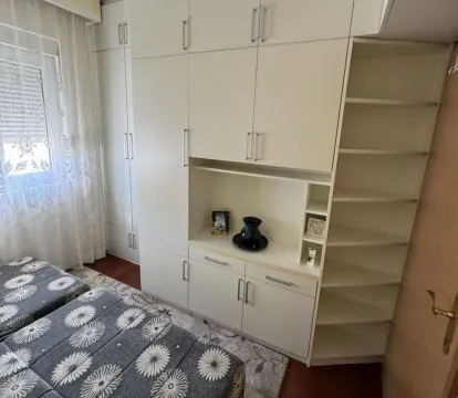 Bright bedroom with a large white wardrobe. - image 10