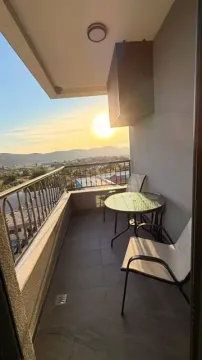 Furnished terrace with a table, chairs, and a view of the surroundings. - image 11