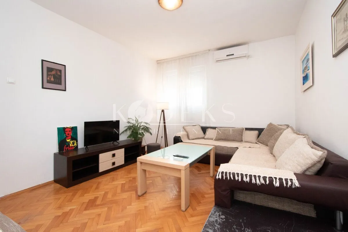 Living room with a sofa, TV, and coffee table.