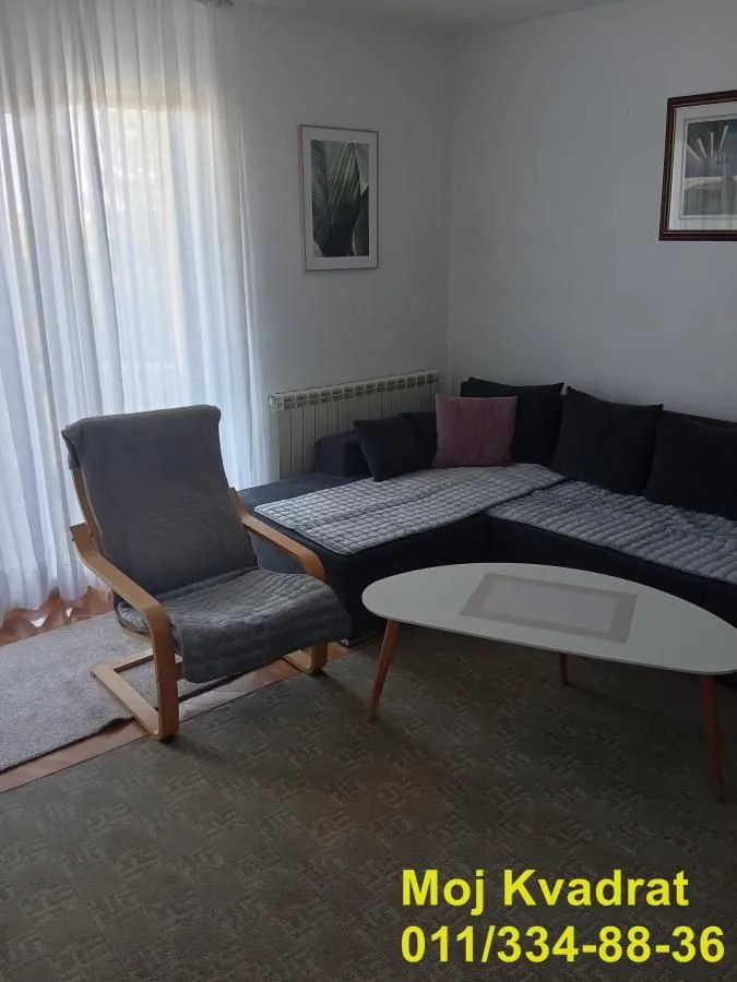 Living room with a sofa set, an armchair, and a coffee table.