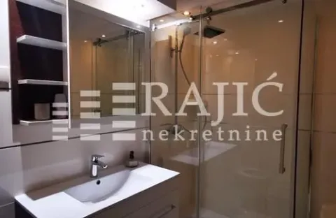 Modern bathroom with a sink, mirror, and shower cabin. - image 9