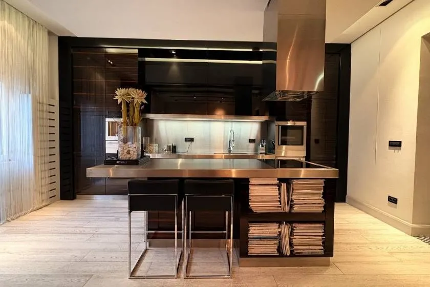 Modern kitchen with dark cabinets and a central island.