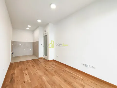 Empty kitchen with hardwood floors and ceramic wall tiles. - image 3