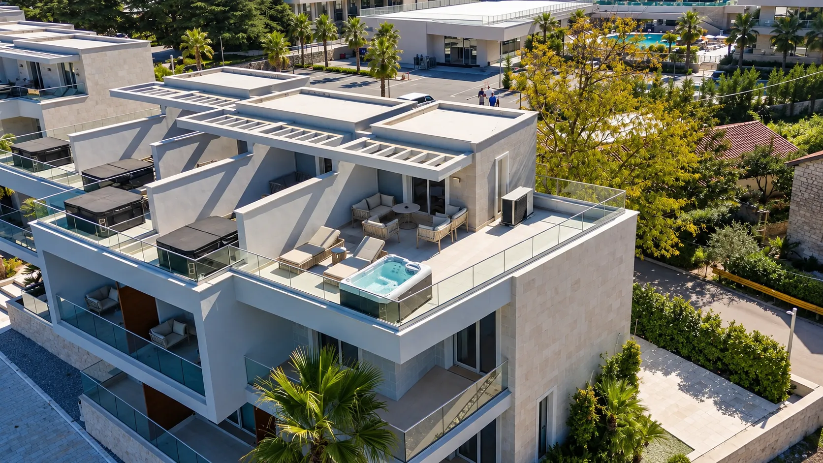 High-angle view of a spacious terrace with a jacuzzi and outdoor seating.