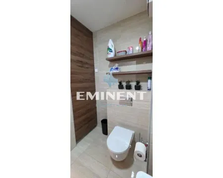 View of the bathroom with a wall-hung toilet and shelves. - image 5