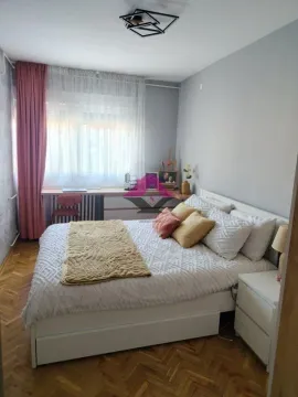 Furnished bedroom with a double bed, a desk, and a window. - image 16