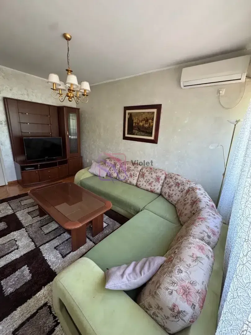 Living room with a sectional sofa, TV, and coffee table.