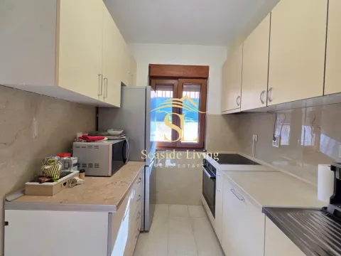 Small equipped kitchen with white cabinets and a window. - image 5